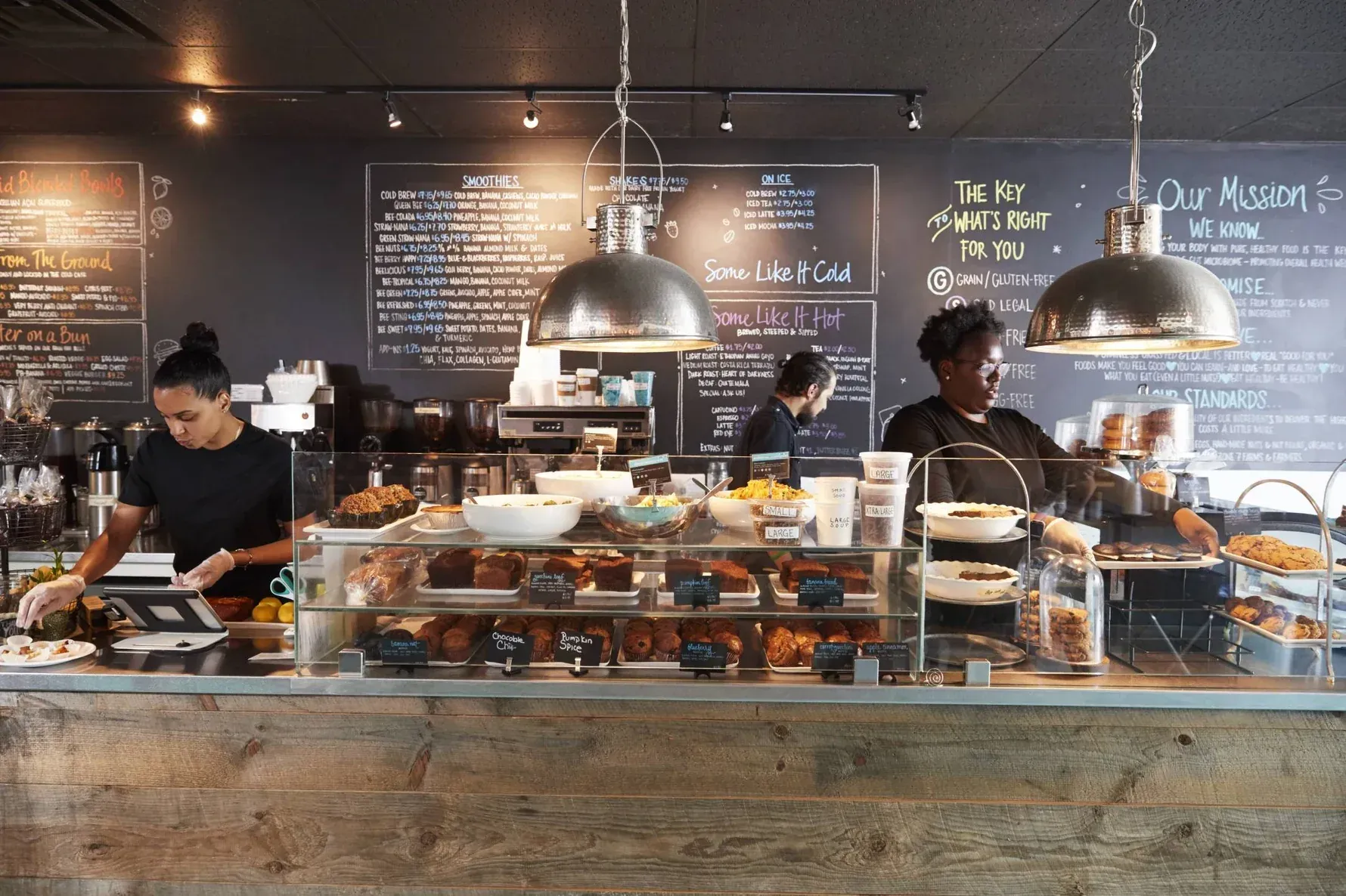 Baristas serving at a busy cafe counter